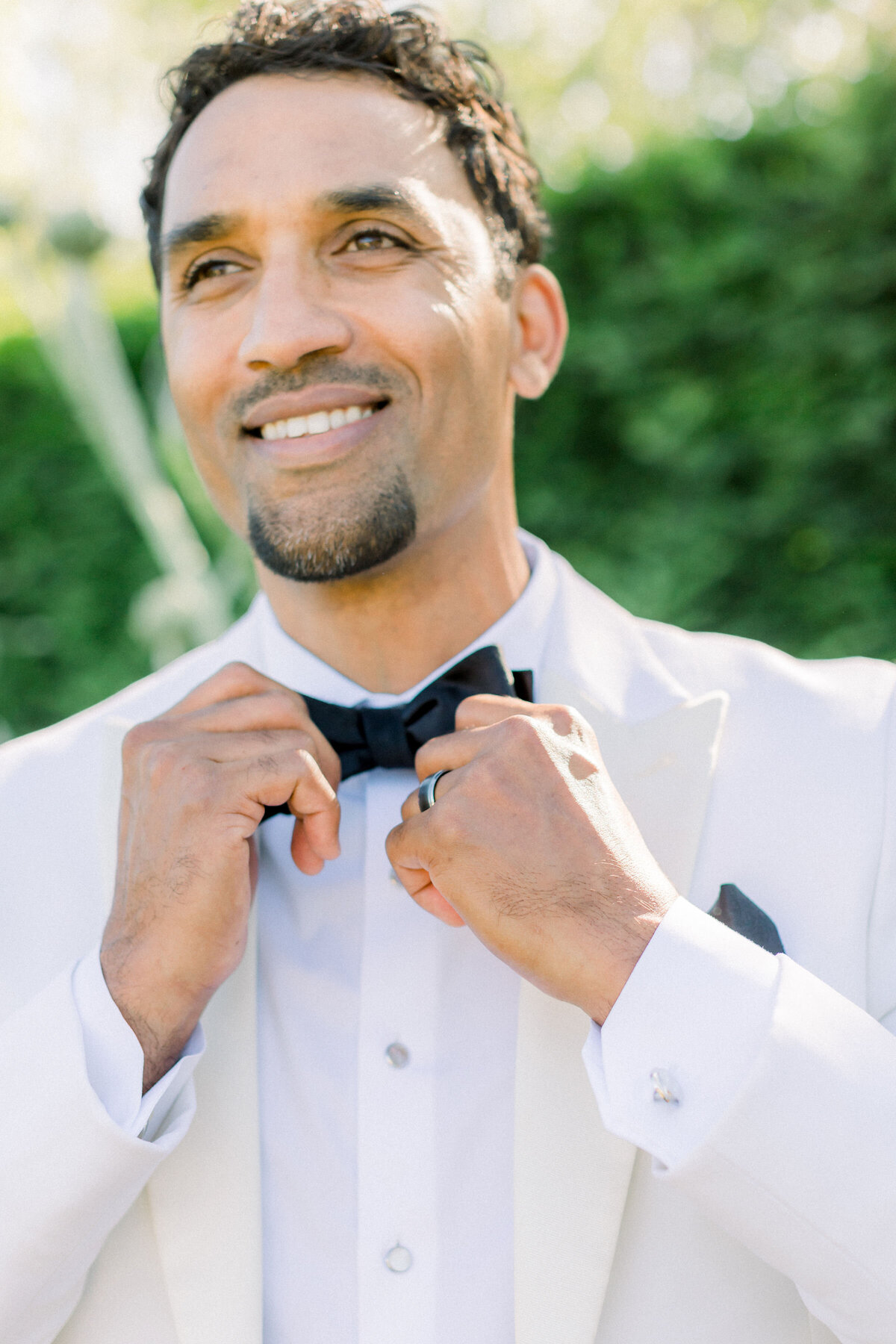 elegant-groom-tuxedo-smiling-portrait-luxurious-setting
