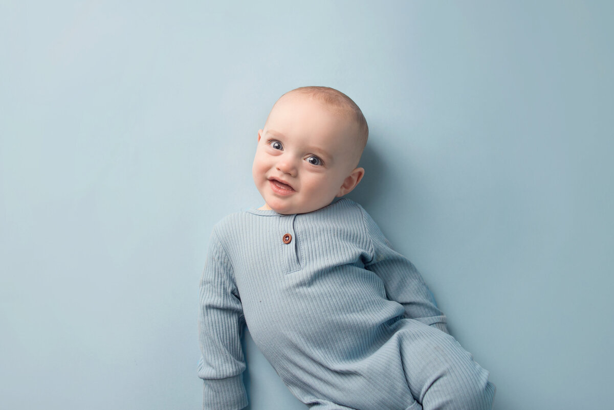 Baby boy wearing blue outfit, during milestone photoshoot with Nashville, TN photographer