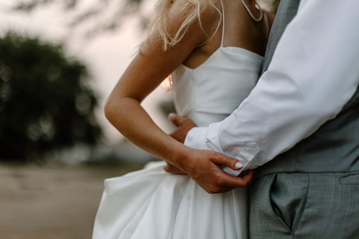bride and groom standing together smiling