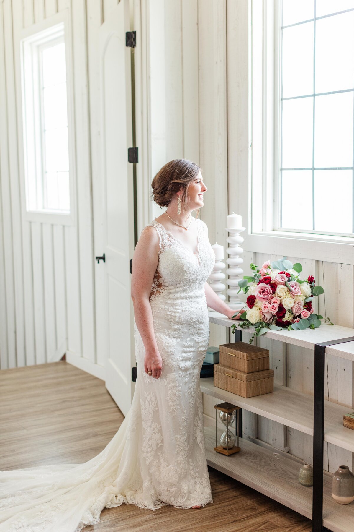 bride stand looking out window of bridal suite at Milestone New Braunfels wedding by Firefly Photography