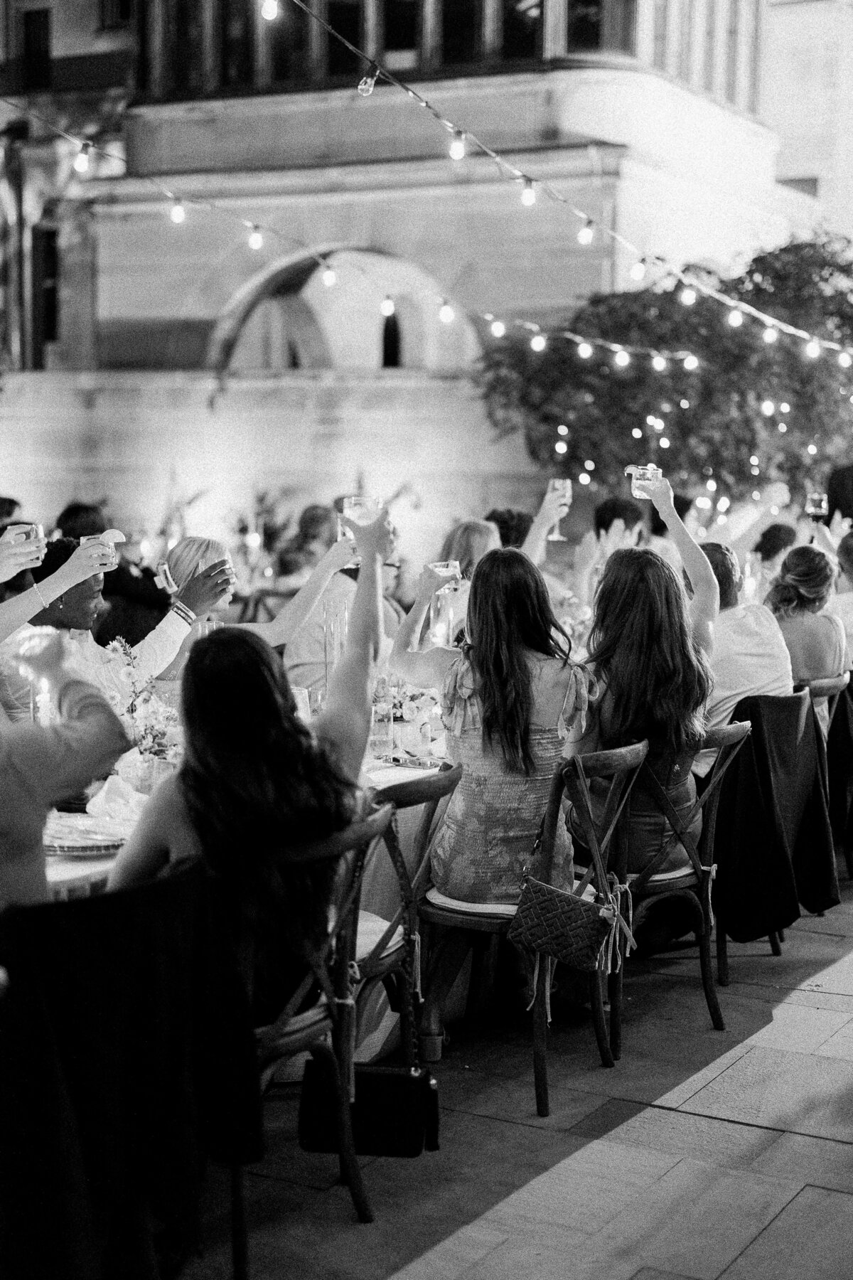 Photo of people toasting to bride and groom