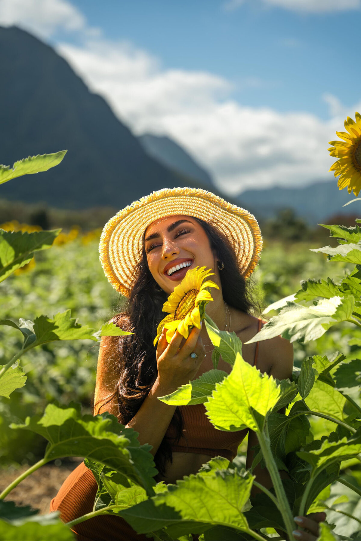 Woman in sunflower fields on the Big Island, with photographer from Hawaii Adventure Portraits