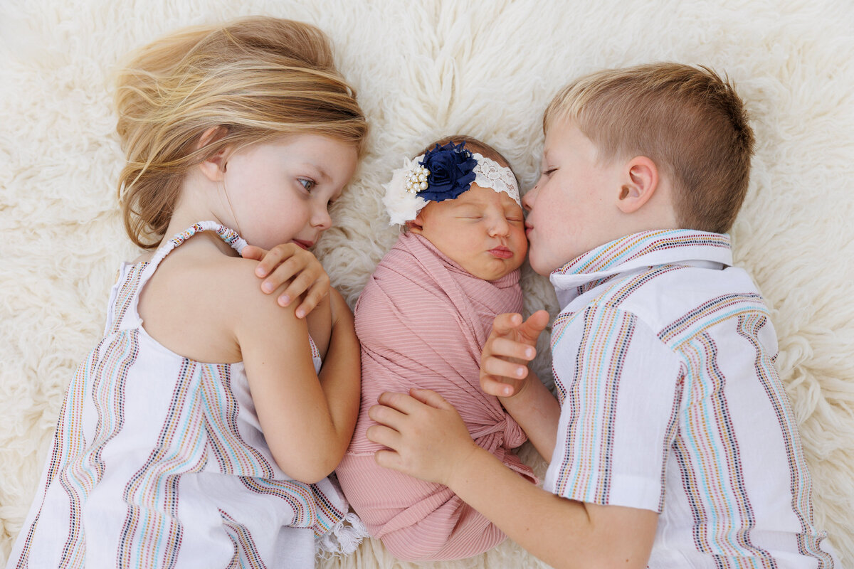 Baby being kiss by brother