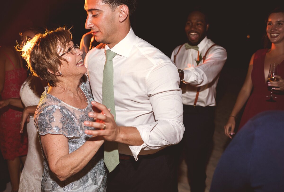 Groom dancing with mother at wedding reception