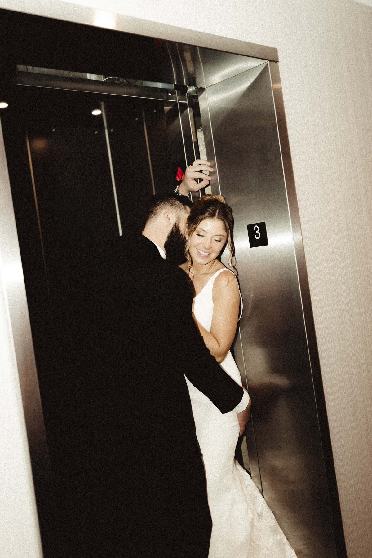 Romantic and steamy bride and groom elevator portrait at hotel wedding venue in Springfield Missouri