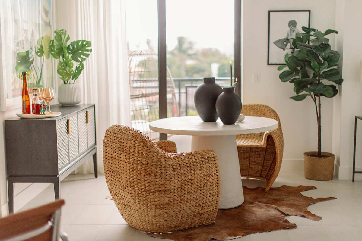 White dining room table with wooden chairs and black accents