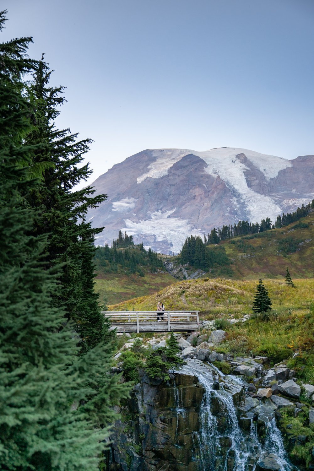 mount rainier elopement on bridge with waterfall