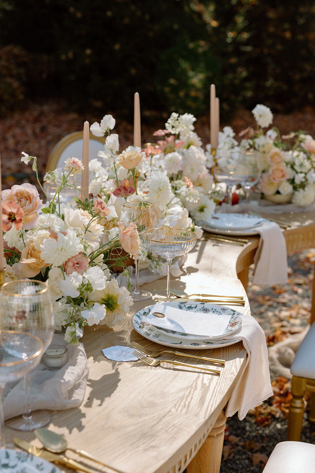 Chic place settings with gold accents at a private outdoor dinner in Tuxedo Park, NY.