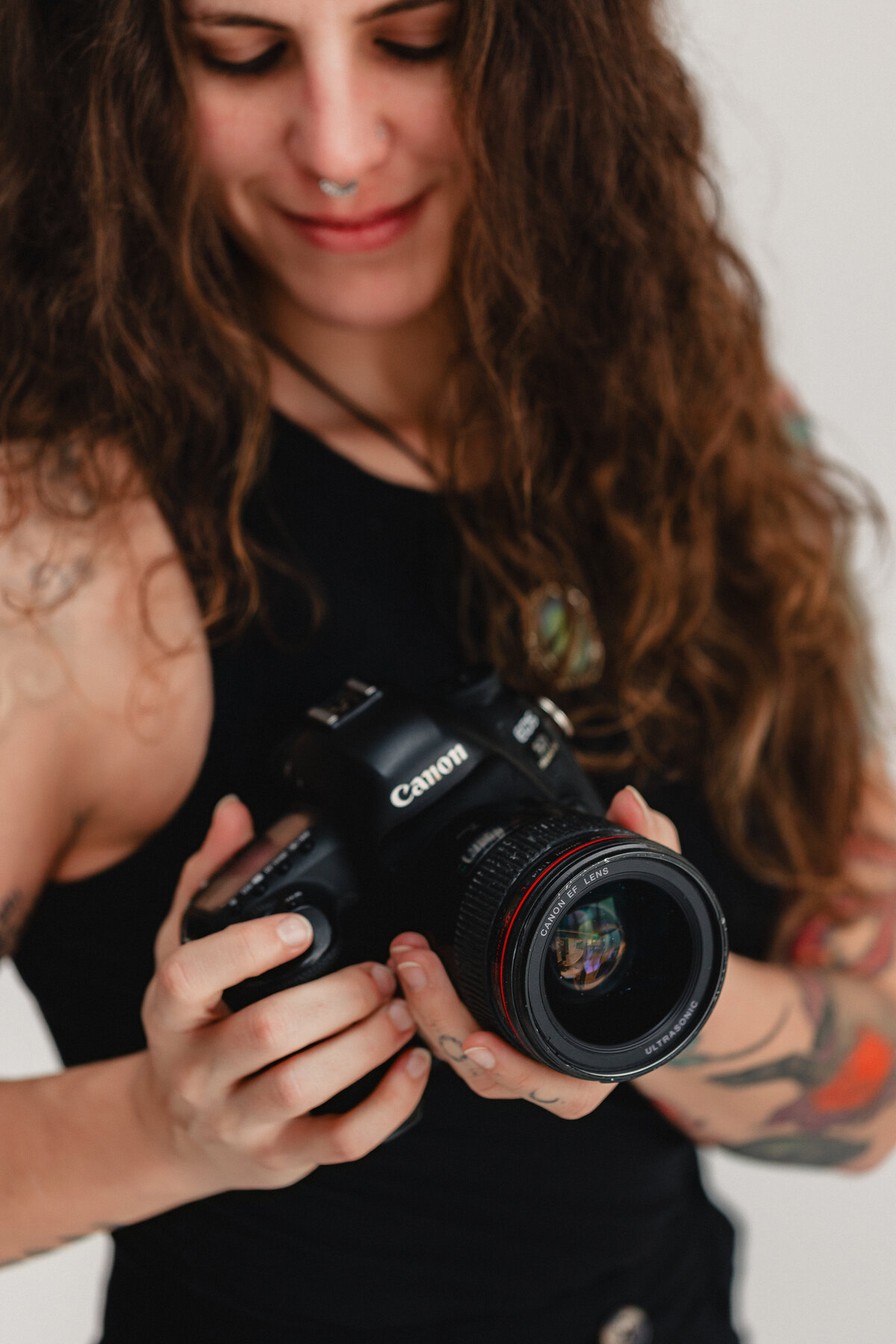 South Shore wedding photographer and yoga teacher posing with camera in hands