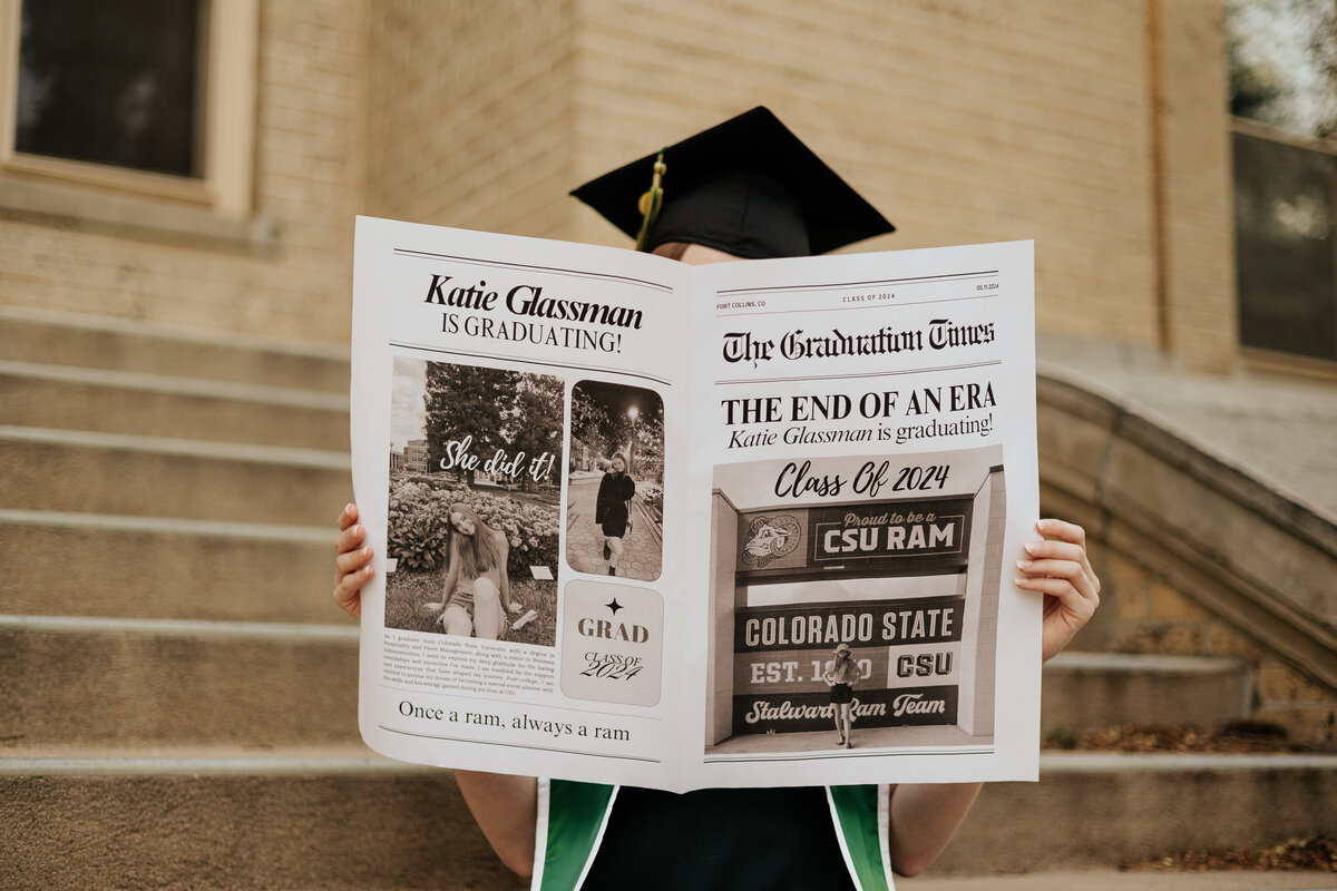 A Colorado State University graduate holds a newspaper during her grad session in Fort Collins, Colorado.