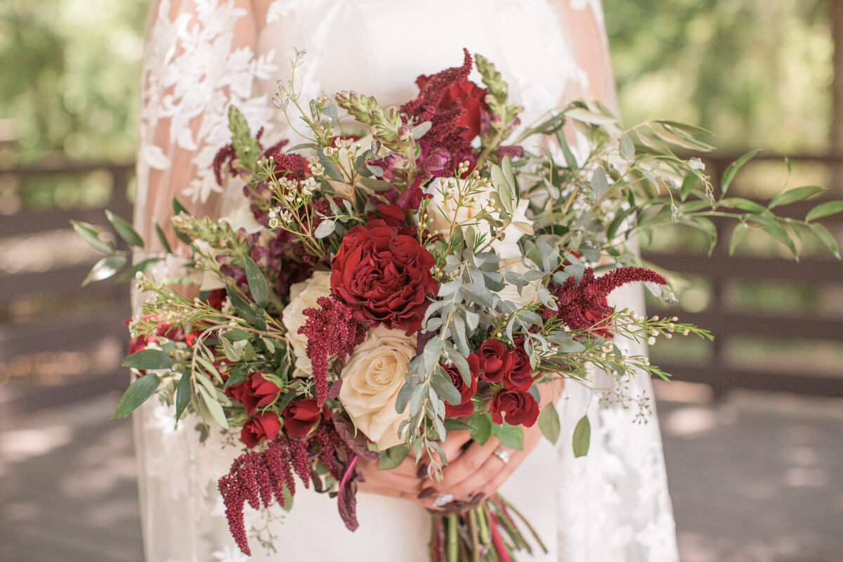 Close up of a stunning bridal bouquet featuring red roses