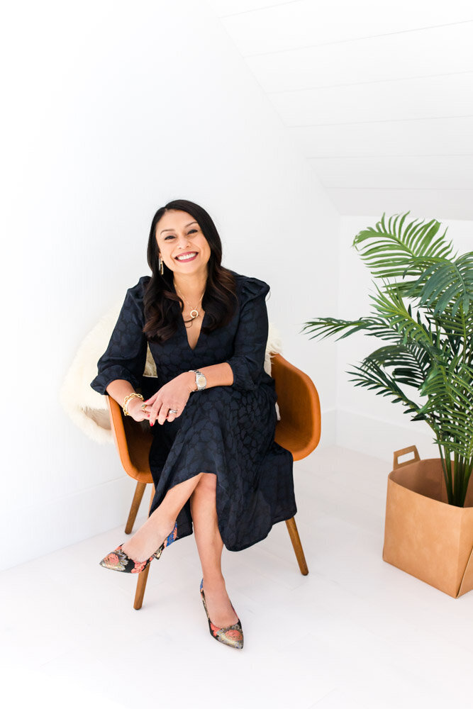 Female entrepreneur headshot with plant