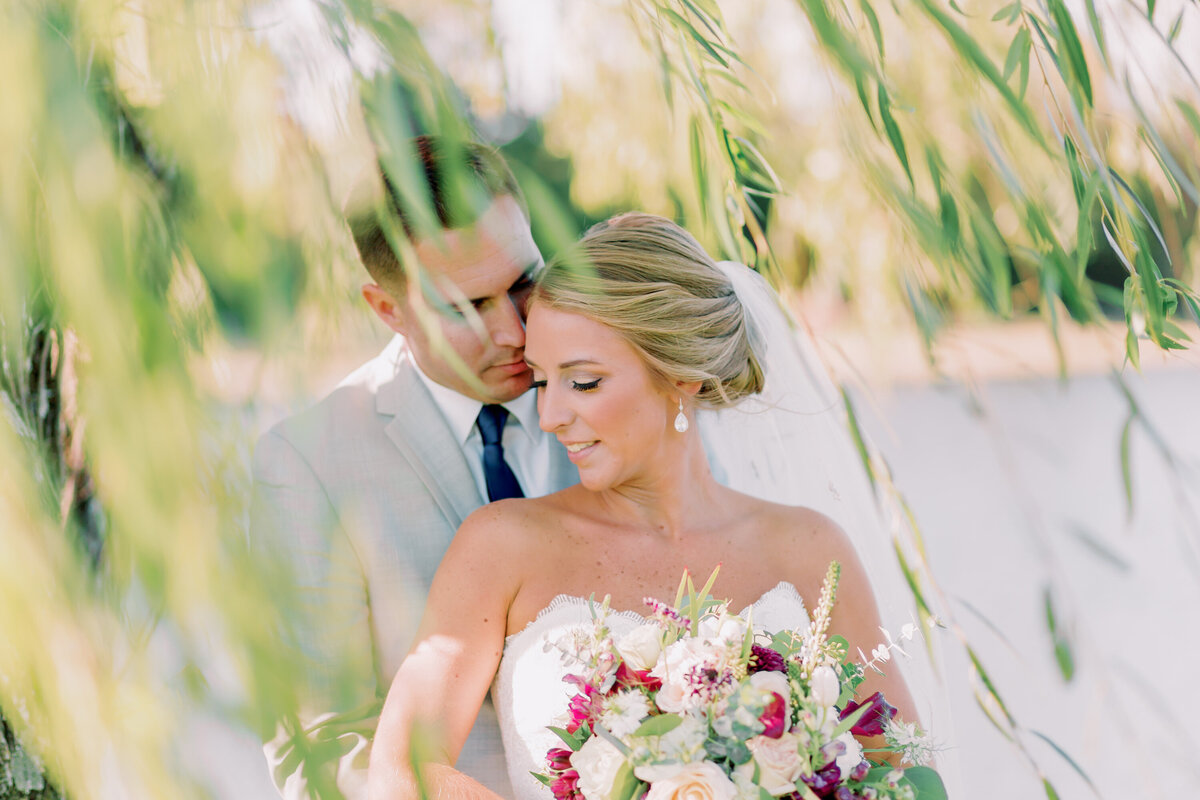 A person standing behind their partner as they lean into each other 