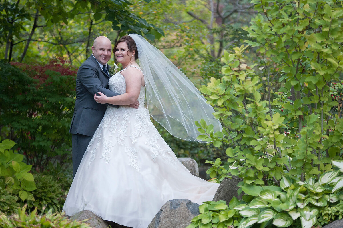 Anderson Japanese Gardens veil blowing on rocks Rockford Wedding Photography