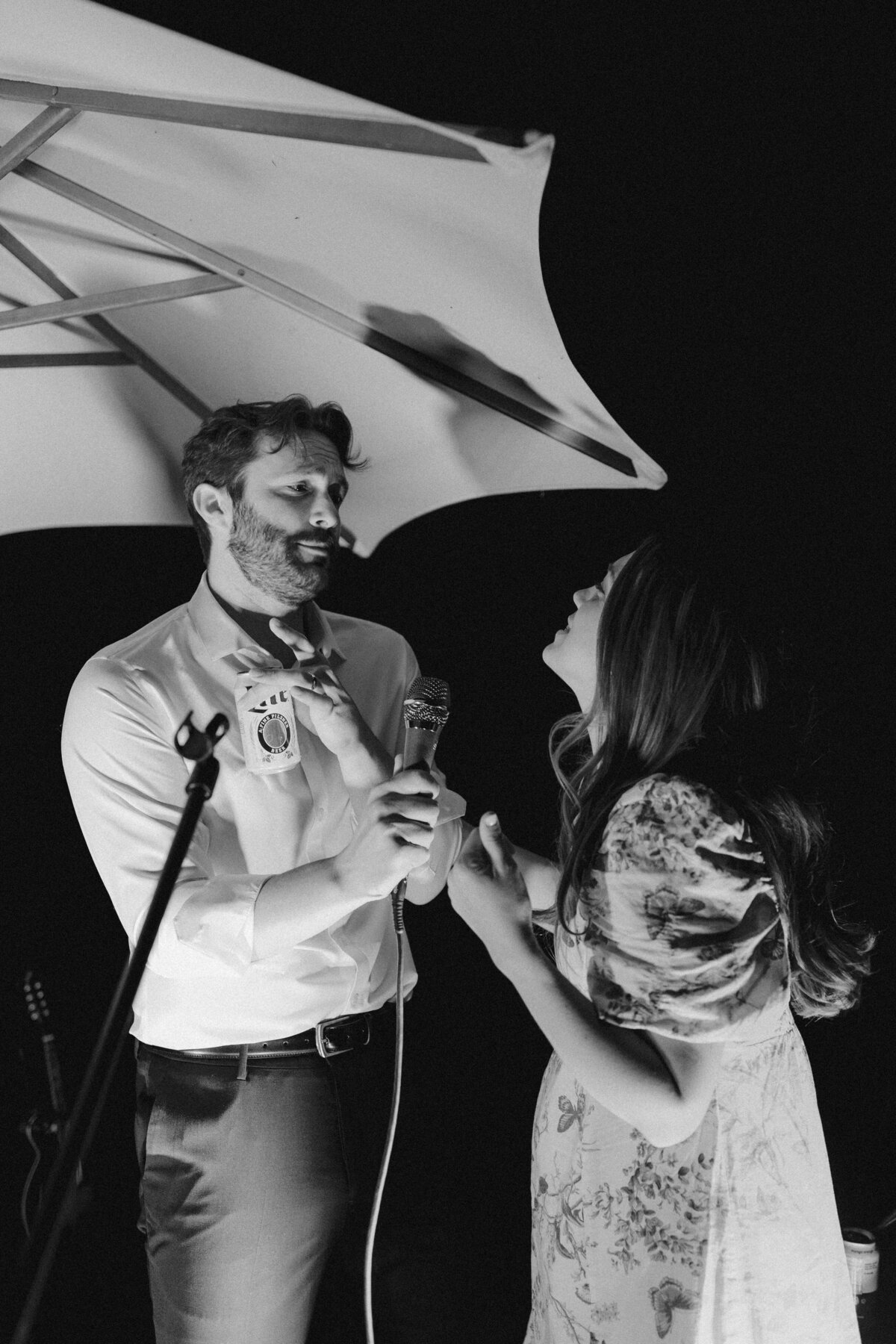 Wedding guests singing into a microphone at Dallenbach Ranch Wedding in Colorado