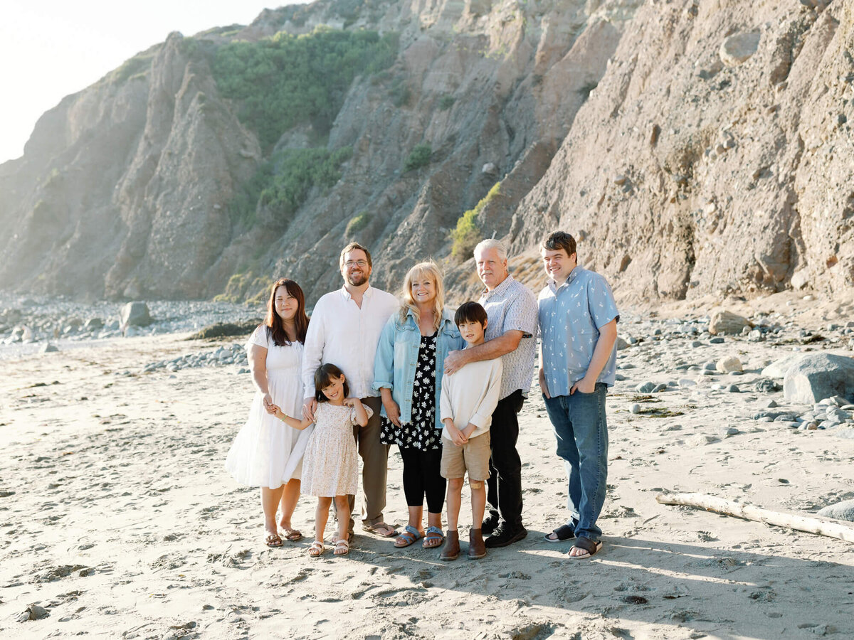 group photo of extended family wearing blue and white color palette at the beach
