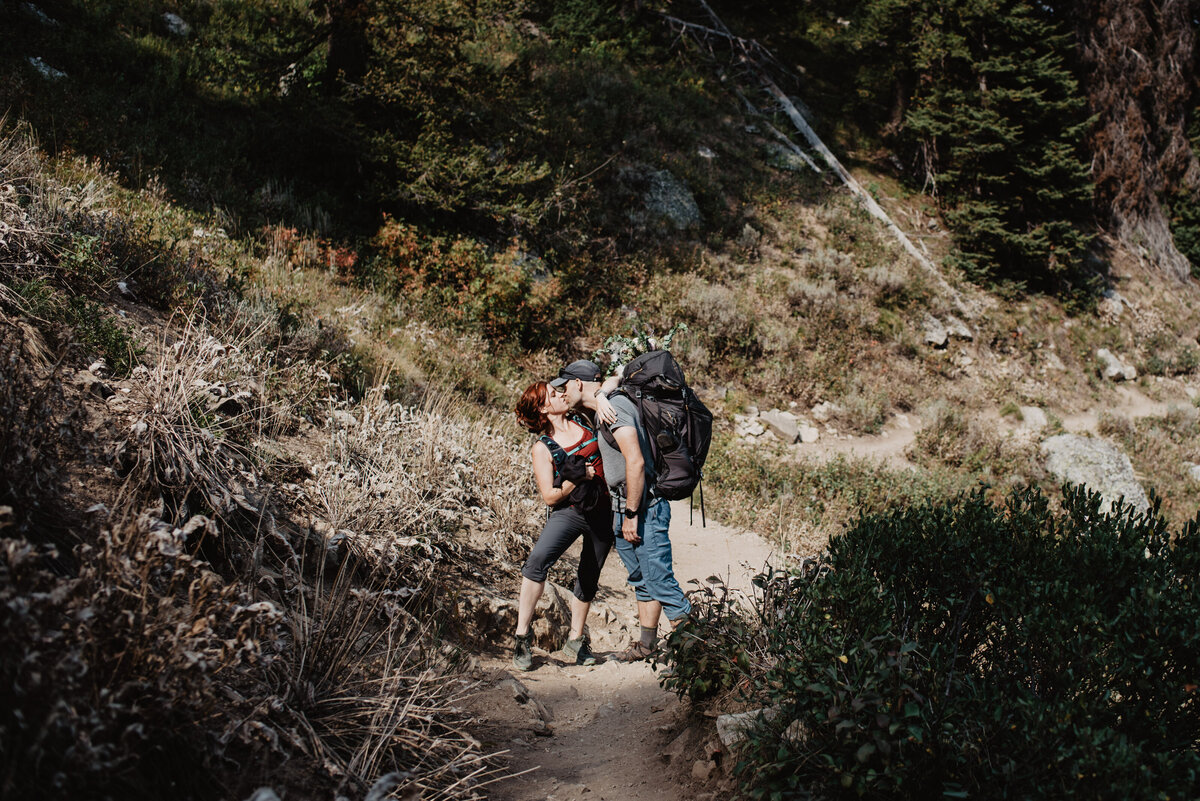 Jackson Hole photographers capture couple kissing while walking down summit