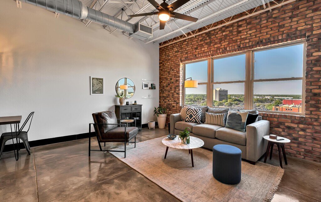 Living room with downtown view in this one-bedroom, one-bathroom vacation rental condo with sleeping space for four is walking distance from the Silos, McLane Stadium, and Baylor University in downtown Waco, TX