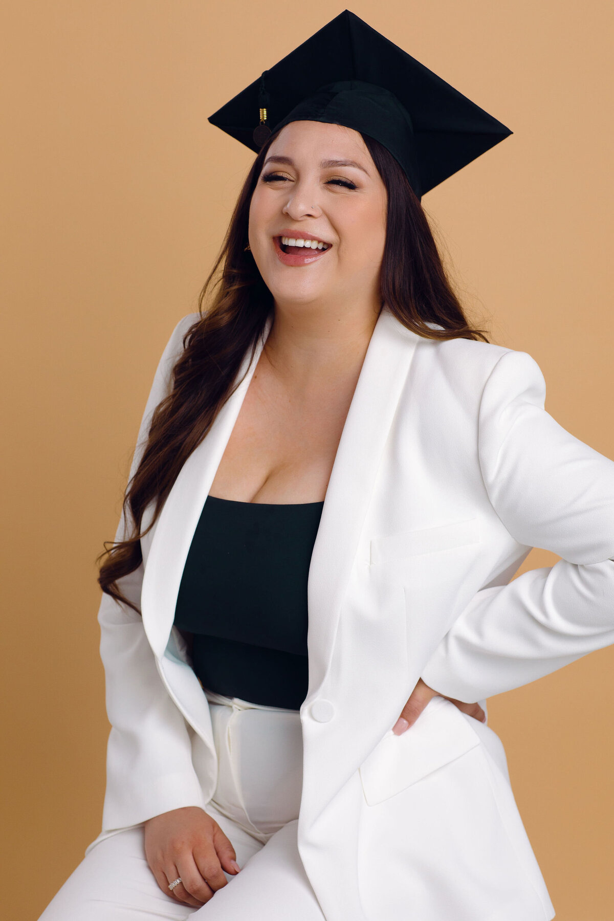 Graduation Portrait Of Young Woman In White Suit And Black Tube Laughing Los Angeles