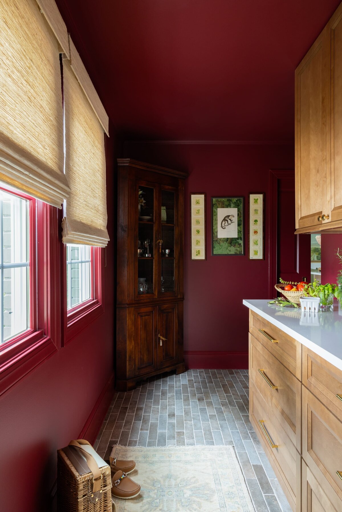 melinda chesson interiors poindexter brick flooring hallway with wooden corner cabinet and red painted walls