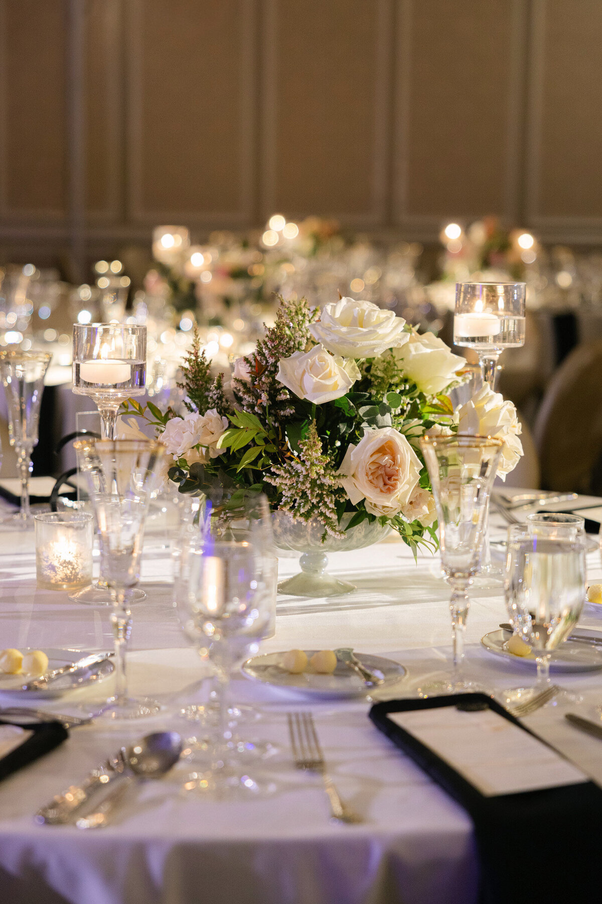close-up of pink rose floral arrangements on a reception table at The Adolphus in Dallas, highlighting luxurious wedding décor.