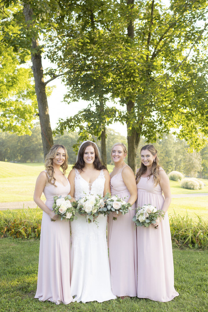 bride and her bridesmaids in light pink - candlelight farms inn wedding
