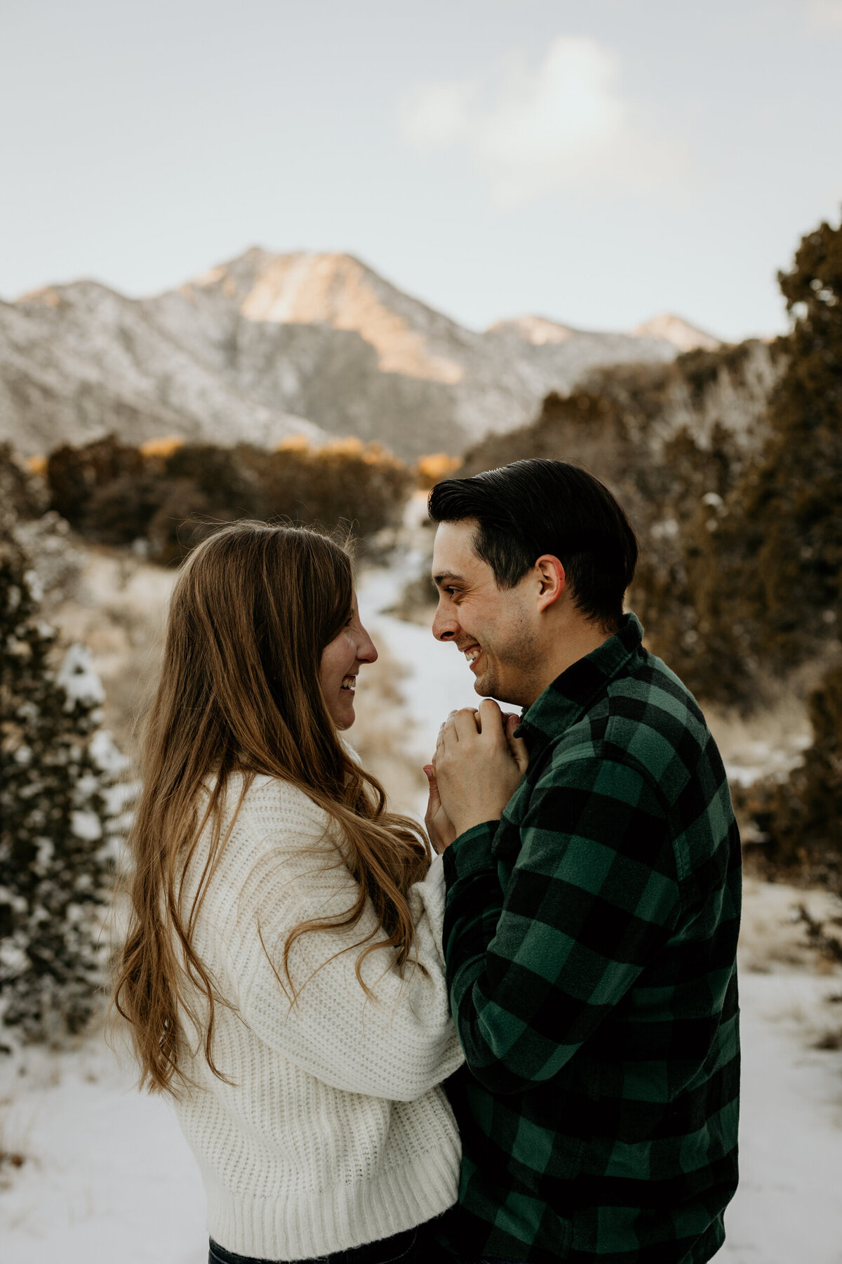 couple holding hands in the snowy mountain in Albuquerque