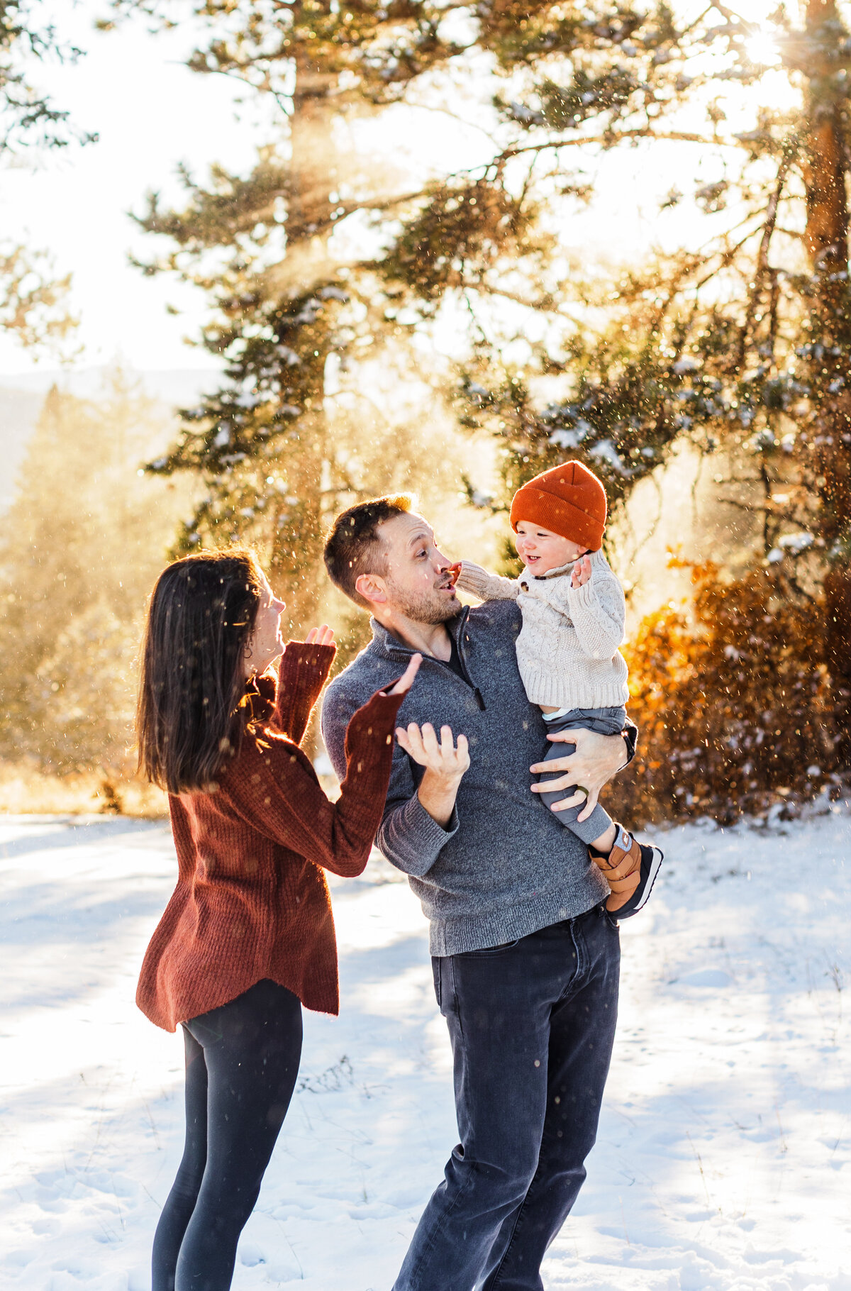 family playing in snow for family photos