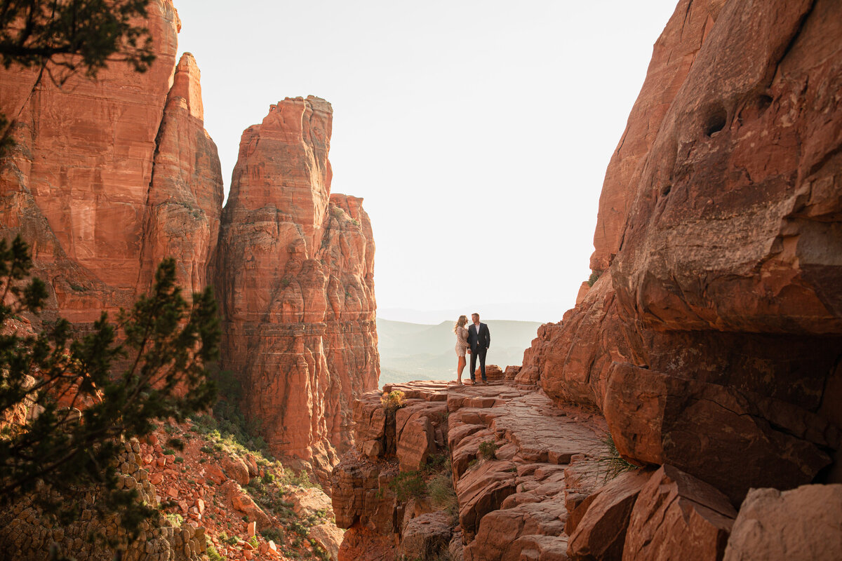 photo of a couple looking at each other on the summit of cathedral rock trail in sedona arizona