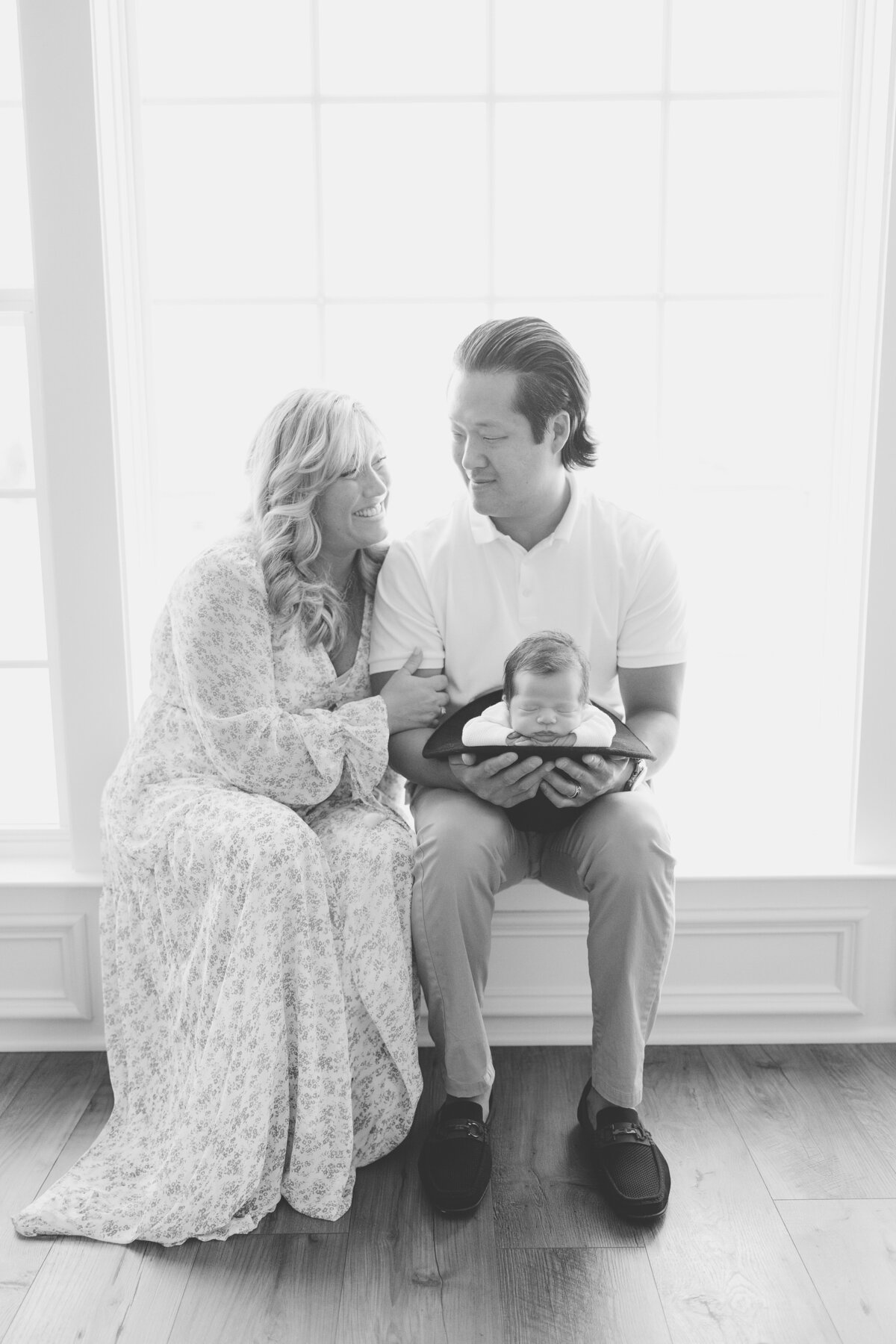 Black and white of mom and dad and baby sleeping in hat for Northern Virginia Newborn Photos