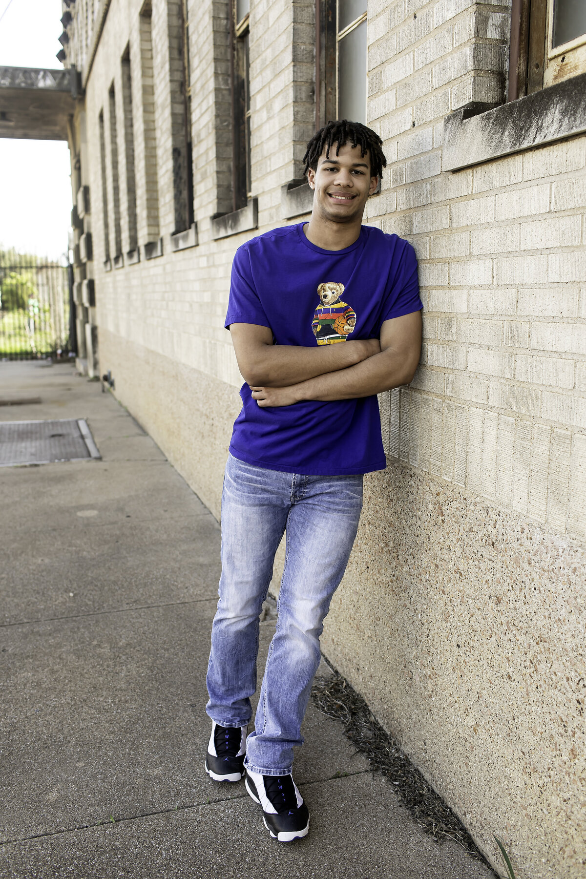 Captured in the heart of the city, a high school senior poses with the hustle and bustle of urban life around them, showcasing both their individuality and city vibes