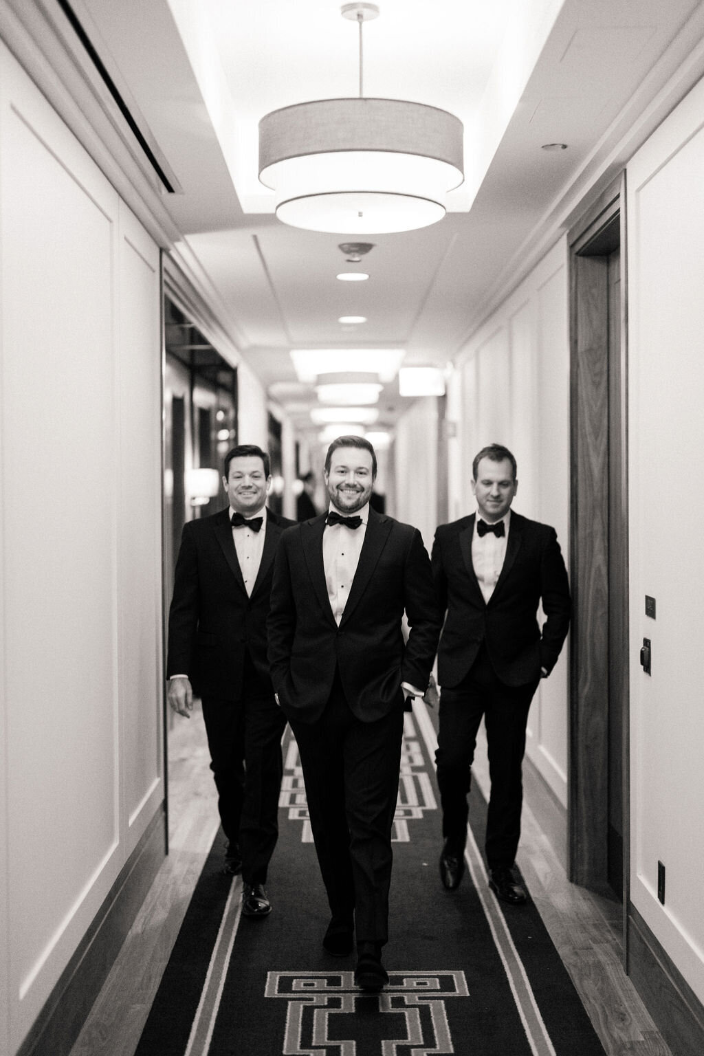 Photo of the groom with groomsmen in the hallway at the Langham. 