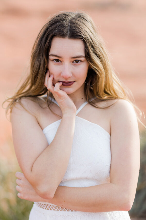 Senior girl with head in hands