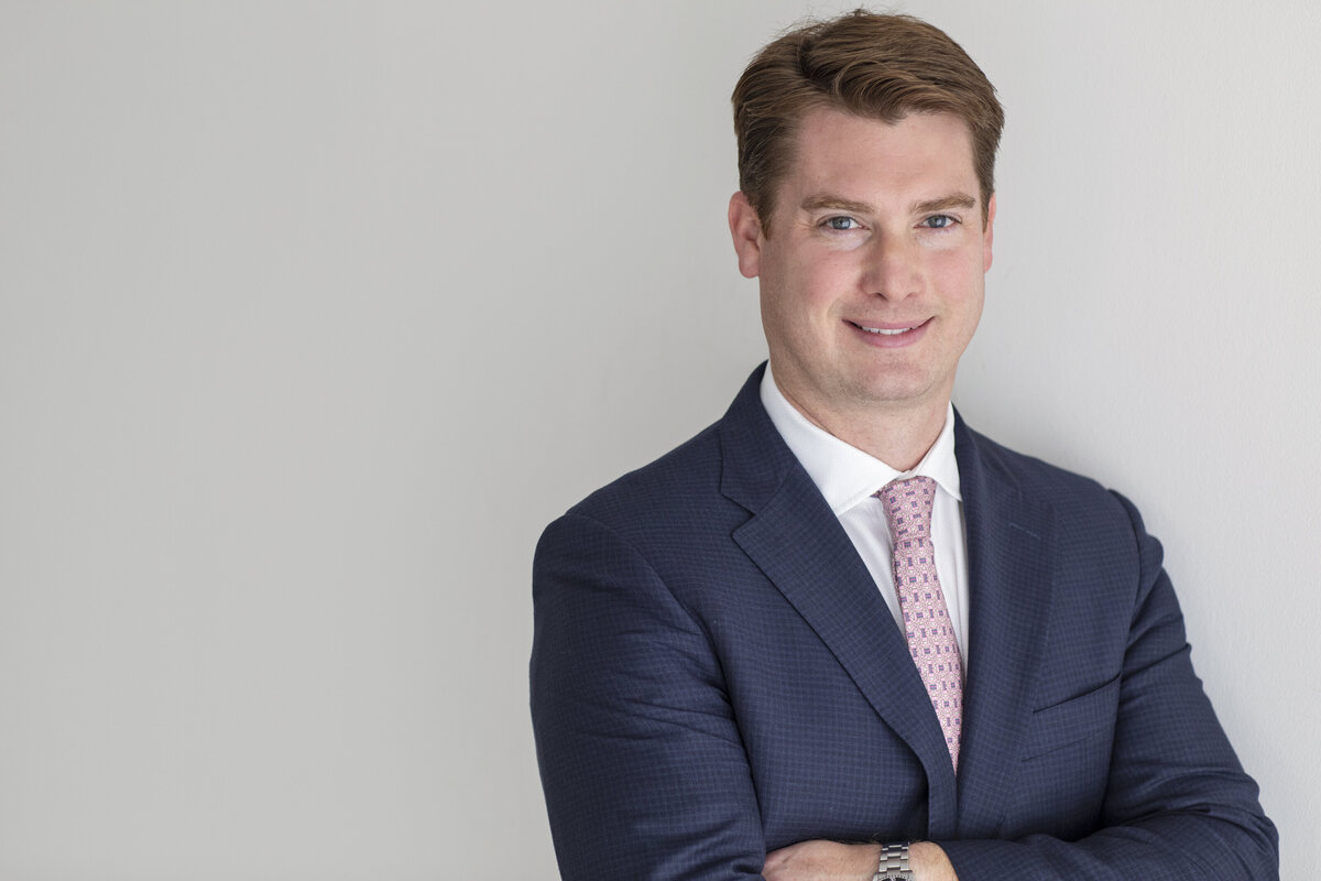 Corporate portrait of a confident man wearing a tailored suit