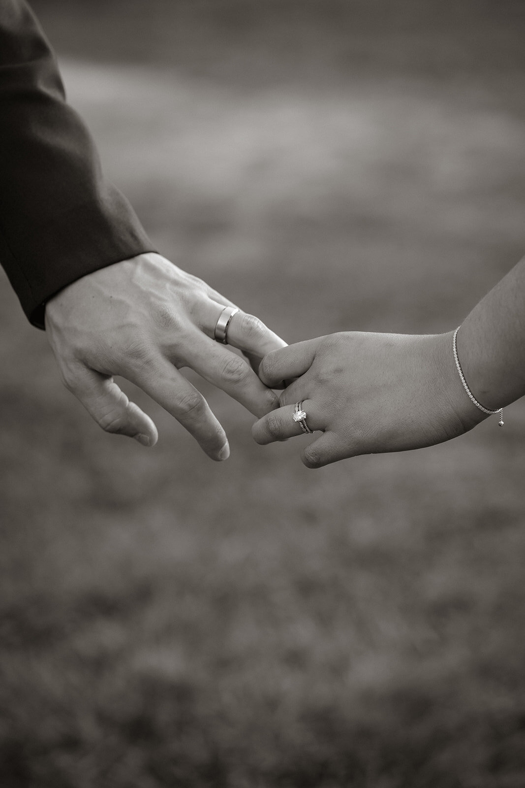close up of hands touching showing wedding rings