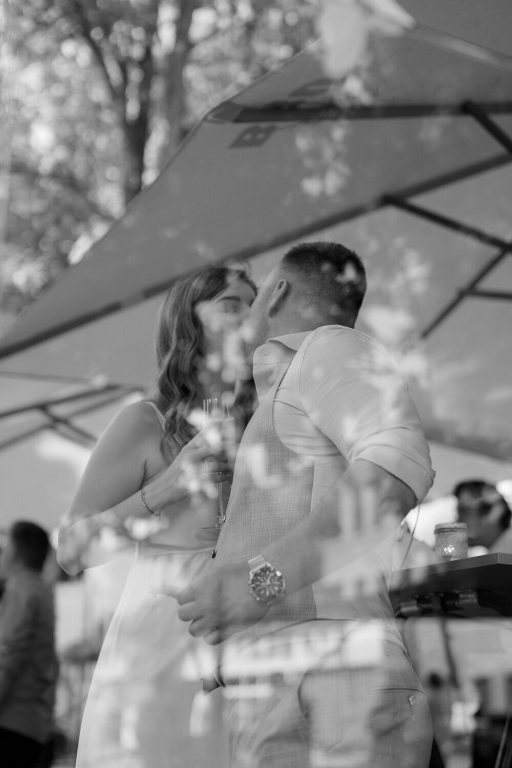 Wedding couple kissing through the glass