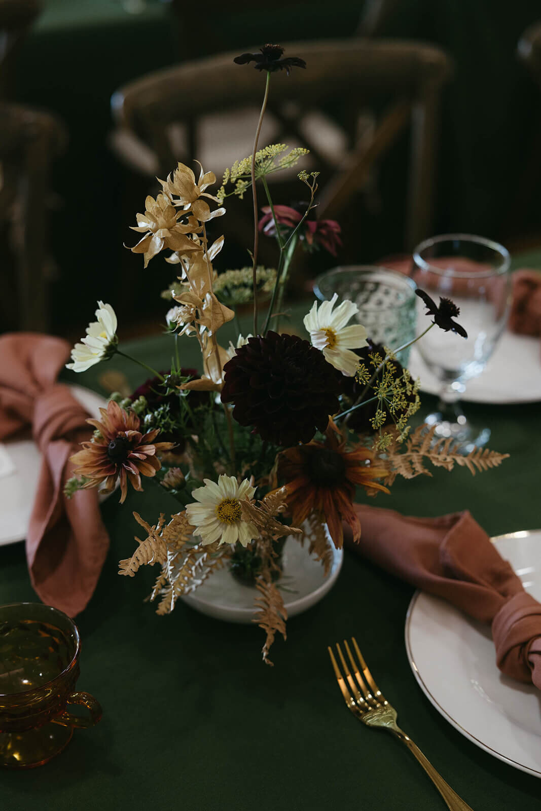 A flower arrangement on a table at wedding reception planned by Birdie June Events.