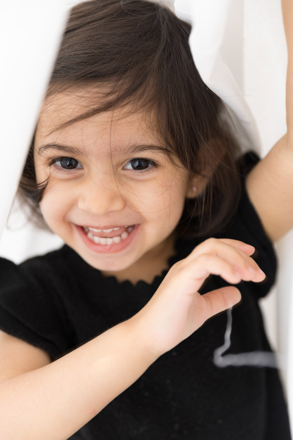 Happy toddler during in-home photoshoot on the pop-up studio.