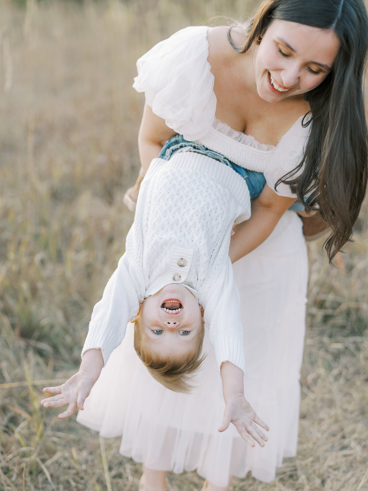 mom flipping son over and laughing