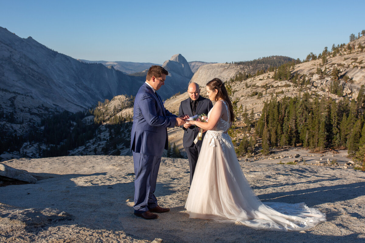 A bride and groom exchange rings during their elopement ceremony in Yosemite National Park.