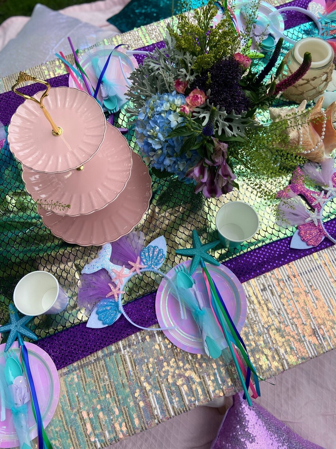 mermaid themed birthday party with metallic picnic decor and pillows