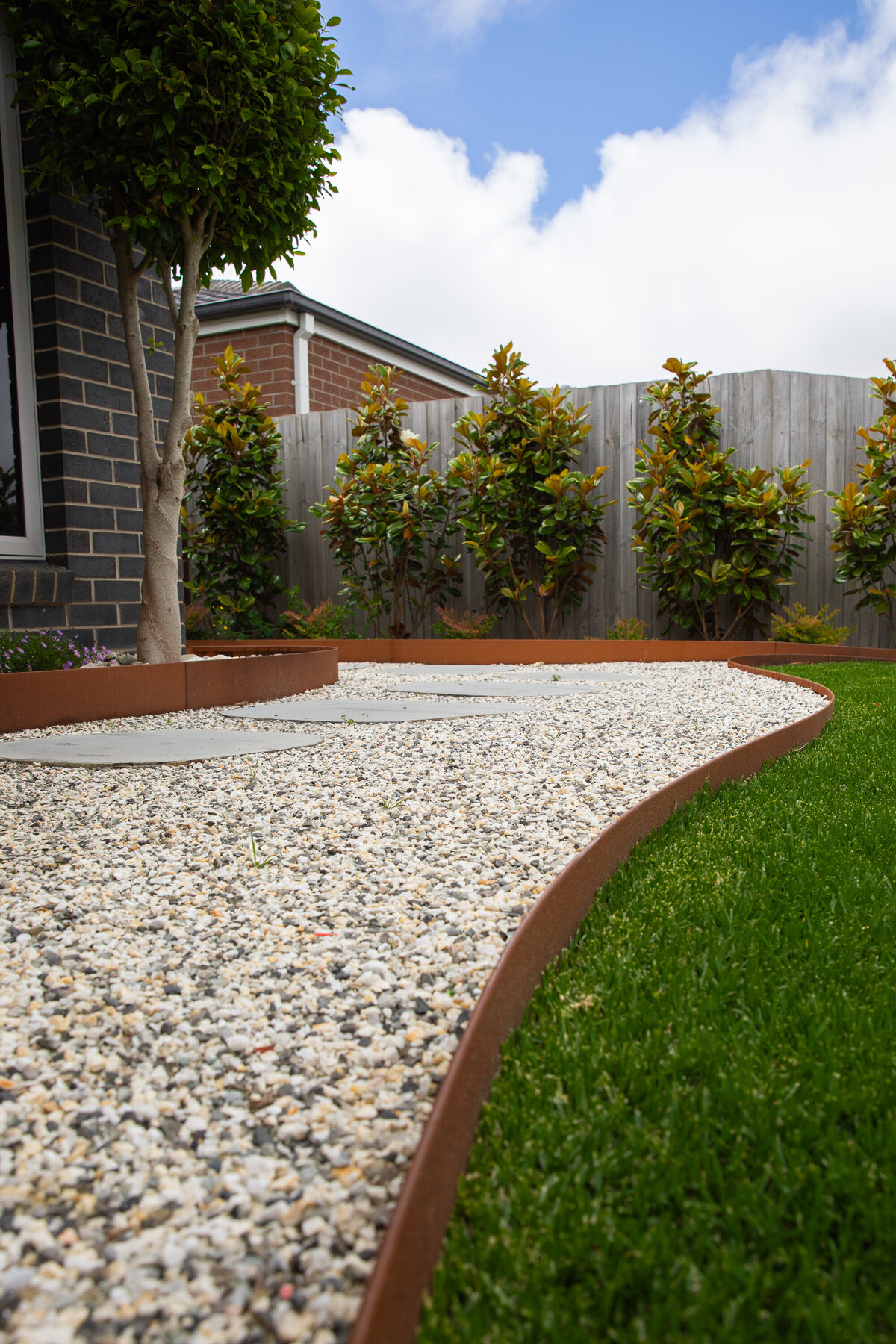 Luscious greenery in this garden design with paving by total landscapes & design