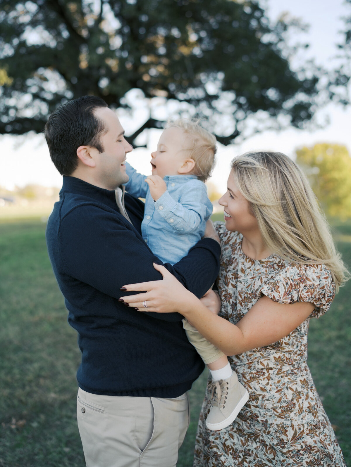 Family of three laughing together by Colorado Springs Family Photographer | Lauren Bounds