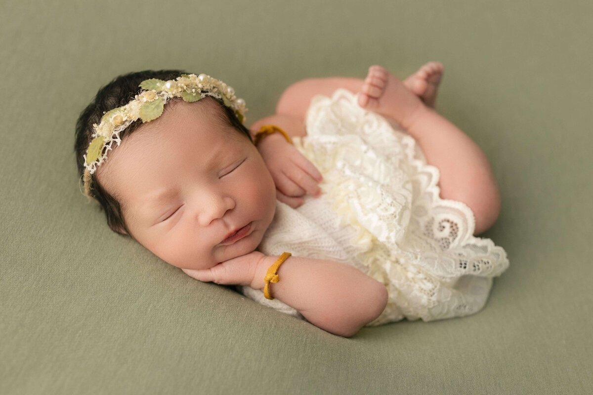 adorable baby girl posed for newborn photoshoot