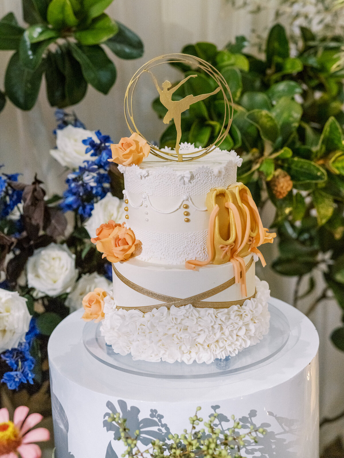 Whimsical ballet-inspired wedding cake with peach florals, pointe shoes, and elegant lace details—perfect for a graceful celebration.