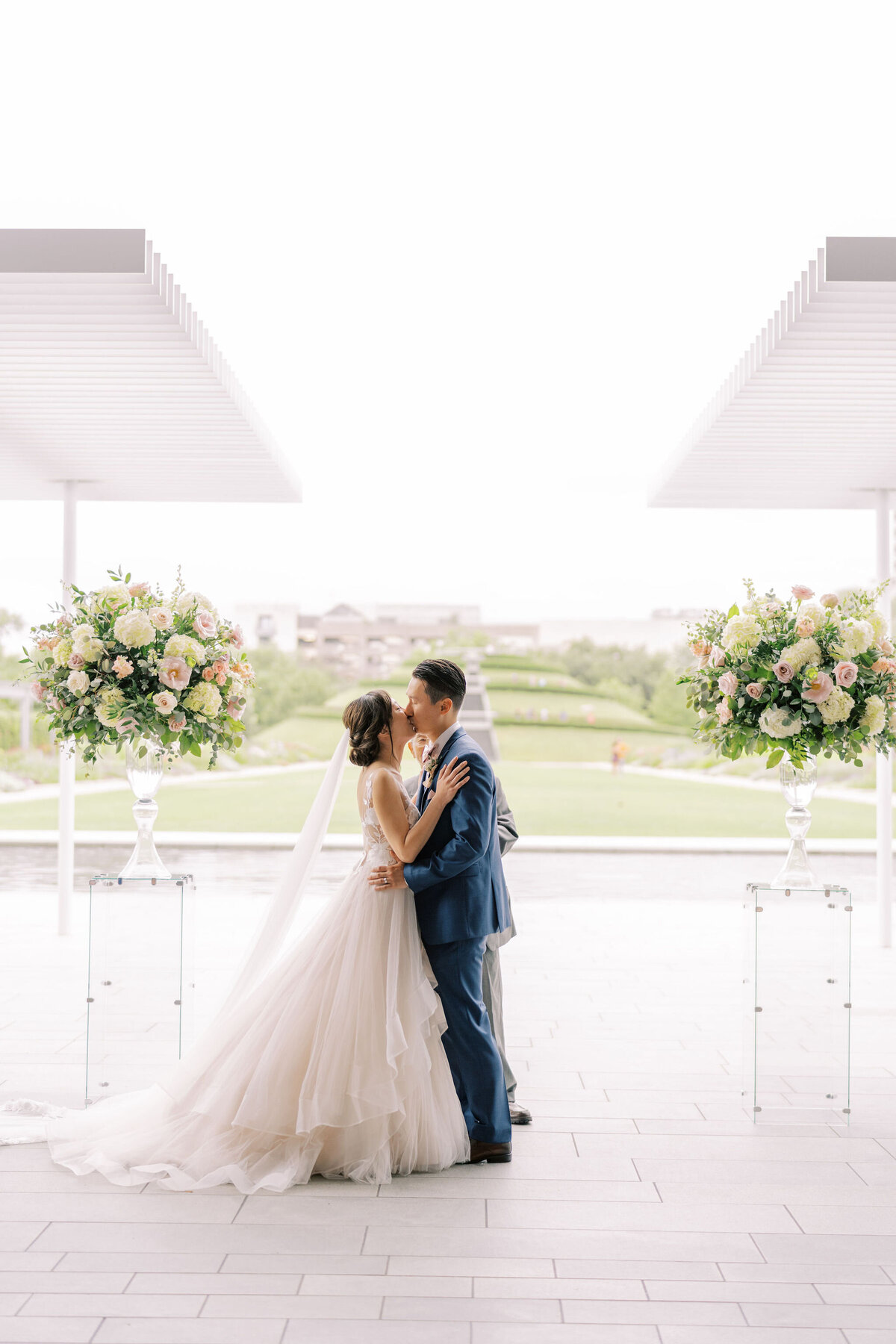 Bride and groom's first kiss in outdoor wedding ceremony in houston, texas