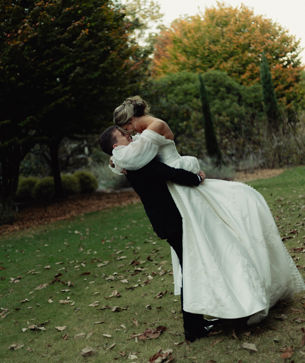 A married couple holds each other in a tender moment.