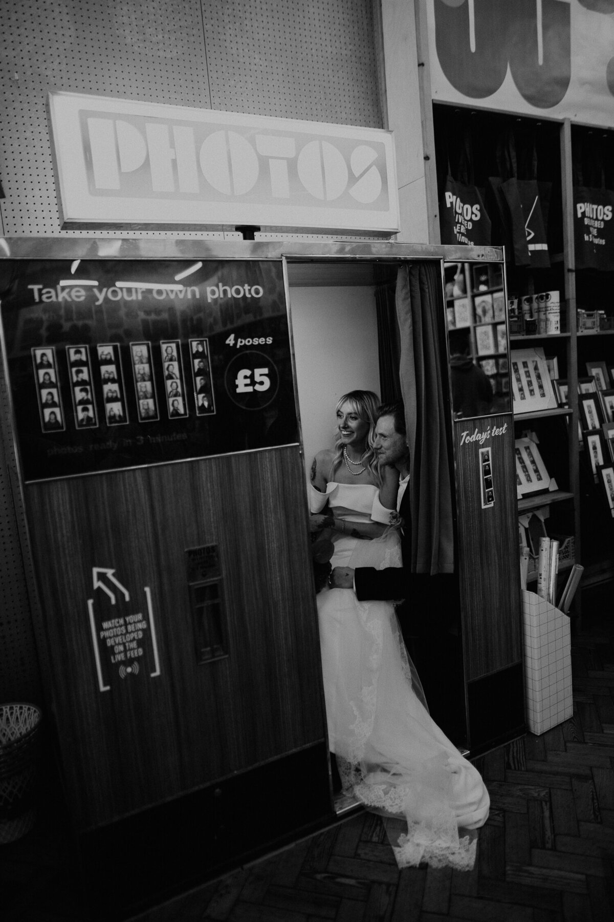 A bride and groom inside an old school film photo booth in Manchester's Northern Quarter. 