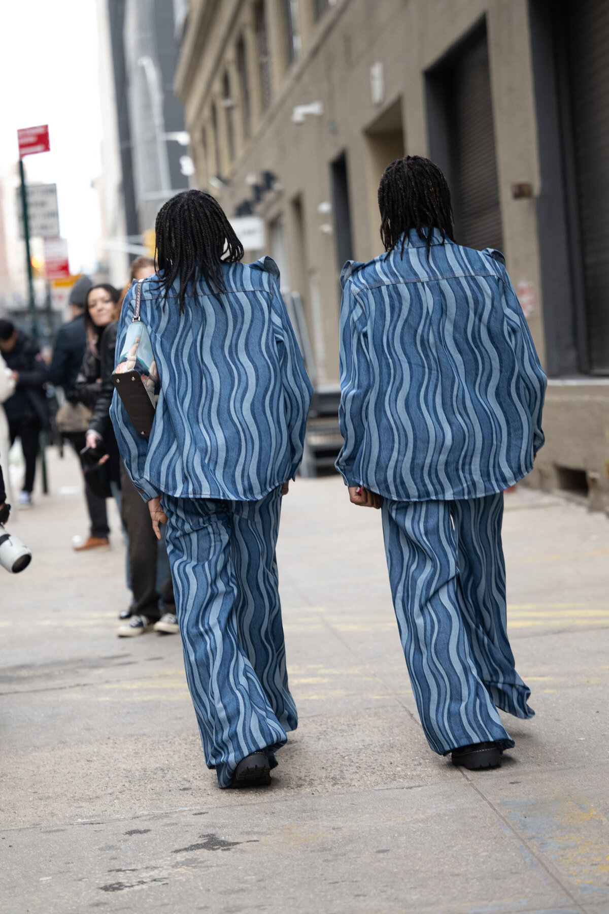 twins in denim walking away