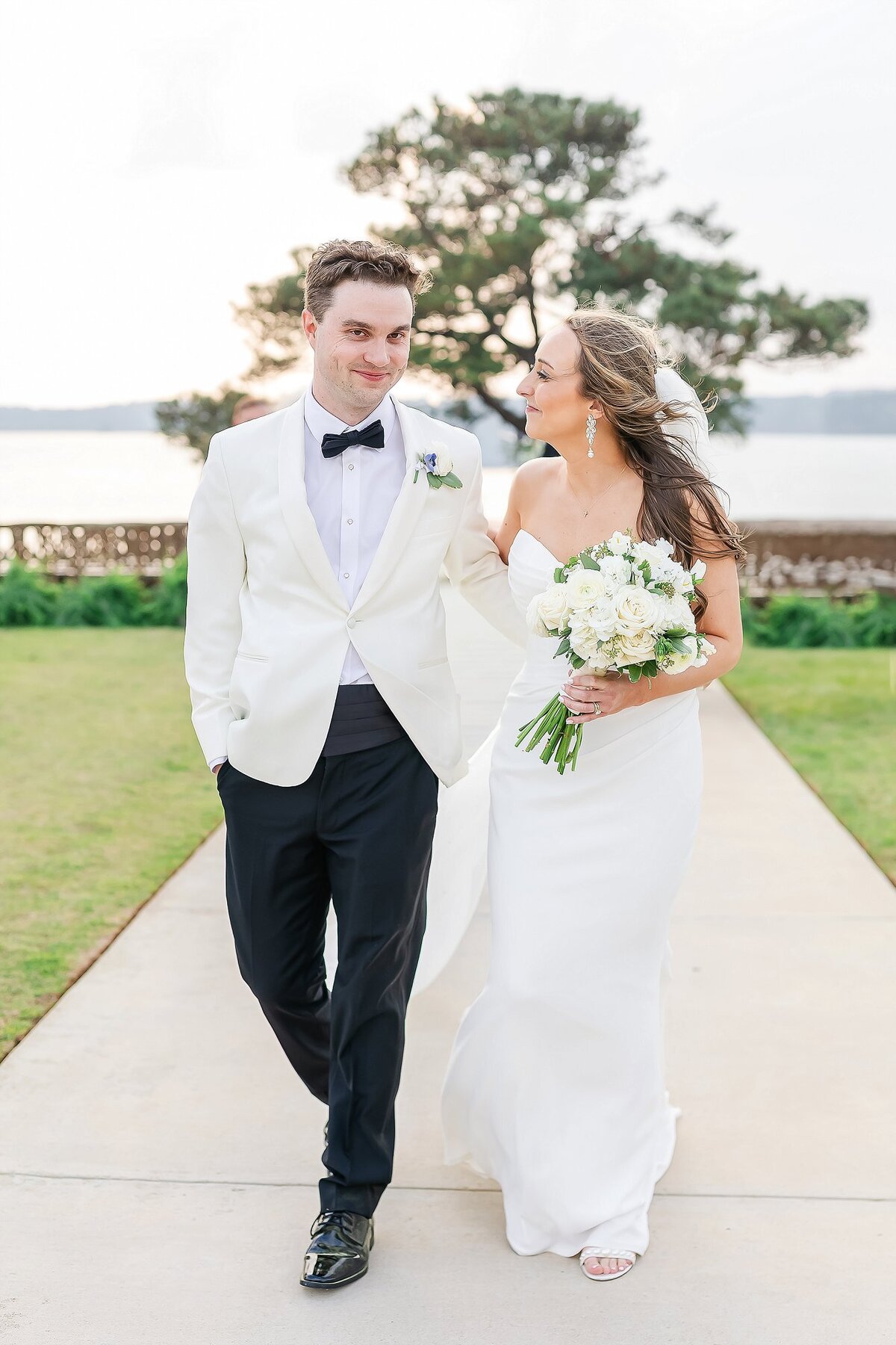 Newlyweds walking hand-in-hand, a moment documented by Alabama wedding photographer Amanda Horne
